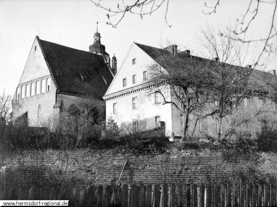 Im Vordergrund das alte Schulgebäude in Kreuzburg 1940, dahinter die evang. Kirche. 